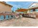 Relaxing patio with seating, umbrella, and grill at 115 Tyler Dr # 203, Sarasota, FL 34236