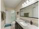 Bathroom with granite countertop and walk-in shower at 1195 Villagio Cir # 201, Sarasota, FL 34237