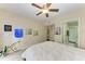 Bedroom with ceiling fan and access to bathroom at 1195 Villagio Cir # 201, Sarasota, FL 34237