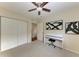 Bedroom with double closets, ceiling fan and art at 1195 Villagio Cir # 201, Sarasota, FL 34237