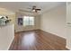 Living room features wood flooring and a large window at 1195 Villagio Cir # 201, Sarasota, FL 34237