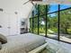 Main bedroom with a wall of windows overlooking a scenic view at 1245 Mill Creek Rd, Bradenton, FL 34212