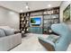 Cozy Gathering room features built-in shelving, a large TV, and comfortable seating at 1245 Mill Creek Rd, Bradenton, FL 34212