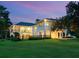 Modern two-story home with a beautifully landscaped yard, at dusk at 1245 Mill Creek Rd, Bradenton, FL 34212