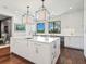 Bright kitchen boasts a spacious marble island, stainless steel appliances, and hardwood floors at 1245 Mill Creek Rd, Bradenton, FL 34212