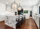 Gourmet kitchen features a large marble island, modern appliances, and hardwood floors at 1245 Mill Creek Rd, Bradenton, FL 34212