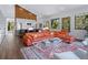 Open-concept living room with orange couch and kitchen area at 1245 Mill Creek Rd, Bradenton, FL 34212