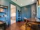 Home office with built-in shelving, hardwood floors and view into butler's pantry at 1245 Mill Creek Rd, Bradenton, FL 34212