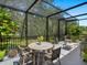 Relaxing screened porch with patio furniture, perfect for outdoor dining at 1245 Mill Creek Rd, Bradenton, FL 34212