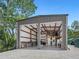 Large workshop with double doors and ample storage shelving at 1245 Mill Creek Rd, Bradenton, FL 34212