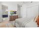 Bright bedroom with a dresser, large bed, and access to a modern bathroom at 1335 2Nd St # 301, Sarasota, FL 34236