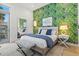 Serene bedroom with leafy wallpaper and private balcony at 1335 2Nd St # 301, Sarasota, FL 34236