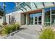 Modern building entrance with glass doors and landscaping at 1335 2Nd St # 301, Sarasota, FL 34236