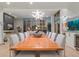 Elegant dining room with a large wooden table and modern chandelier at 1335 2Nd St # 301, Sarasota, FL 34236