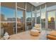 Bright sunroom with city views, comfortable seating, and access to outdoor patio at 1335 2Nd St # 301, Sarasota, FL 34236