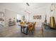 Bright dining room with modern table and chairs, wood accent cabinet, and a chandelier at 14817 Montello Way, Bradenton, FL 34211