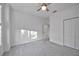 Bright bedroom with carpet, ceiling fan, and double-door closet at 15344 Serene Shores Loop, Bradenton, FL 34211