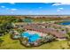 Community pool with lounge chairs and surrounding landscaping at 17921 Canopy Pl, Bradenton, FL 34211