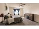 Spacious bedroom with queen bed, dresser, and fireplace at 17921 Canopy Pl, Bradenton, FL 34211
