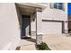 Front entrance with gray door and stone accents at 17921 Canopy Pl, Bradenton, FL 34211