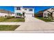 Two-story home with light gray siding, attached garage, and landscaped yard at 17921 Canopy Pl, Bradenton, FL 34211