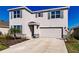Two-story house with gray shutters, stone accents, and a two-car garage at 17921 Canopy Pl, Bradenton, FL 34211