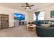 Bright and airy living area with a large TV, comfortable seating and a ceiling fan at 17921 Canopy Pl, Bradenton, FL 34211