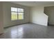 Bright living room with large window and gray tile flooring at 17921 Canopy Pl, Bradenton, FL 34211