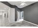 Neutral bedroom offering a ceiling fan, closet, and access to a bathroom at 2063 Lynx Run, North Port, FL 34288
