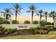 Community sign for Bobcat Trail surrounded by mature palm trees, manicured shrubs and landscaping at 2063 Lynx Run, North Port, FL 34288