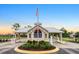 Bobcat Trail community entrance gate featuring an American flag, visitor parking and meticulously maintained landscaping at 2063 Lynx Run, North Port, FL 34288