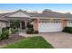 Exterior view of charming villa with two-car garage and landscaped yard at 2063 Lynx Run, North Port, FL 34288