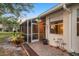 Exterior shot of house with brick paver path to enclosed lanai and lake view at 2063 Lynx Run, North Port, FL 34288