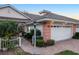 Front view of villa with attractive landscaping and two-car garage at 2063 Lynx Run, North Port, FL 34288