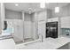 Well-lit kitchen with white cabinets and a black fridge at 2063 Lynx Run, North Port, FL 34288
