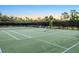 Well-maintained community tennis court featuring professional nets and a perimeter fence at 2063 Lynx Run, North Port, FL 34288