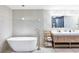 Spa-like bathroom with double vanity, soaking tub, and modern fixtures at 220 Ciboa Ave, North Port, FL 34287