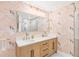 Charming bathroom with double vanity, bird wallpaper, and modern fixtures at 220 Ciboa Ave, North Port, FL 34287