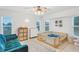 Bedroom with crib, sofa, and ample natural light at 220 Ciboa Ave, North Port, FL 34287