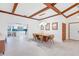 Modern dining room with a long wooden table and view of the kitchen at 220 Ciboa Ave, North Port, FL 34287