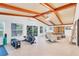 Bright home gym with wood ceiling beams, elliptical, and sauna at 220 Ciboa Ave, North Port, FL 34287