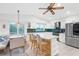 Modern kitchen with white cabinets, quartz countertops, and a green tile backsplash at 220 Ciboa Ave, North Port, FL 34287