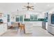 Updated kitchen with white cabinets, green tile backsplash, and island at 220 Ciboa Ave, North Port, FL 34287
