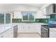 Bright kitchen featuring white shaker cabinets and stainless steel appliances at 220 Ciboa Ave, North Port, FL 34287
