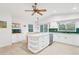 Spacious kitchen with island, white cabinets, and a green tile backsplash at 220 Ciboa Ave, North Port, FL 34287
