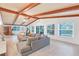 Open living area with vaulted ceilings, exposed beams, and a cozy fireplace at 220 Ciboa Ave, North Port, FL 34287