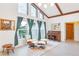 Living room with large windows, mid-century modern furniture and a piano at 220 Ciboa Ave, North Port, FL 34287
