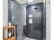 Walk-in shower with dark tile, built-in seat, and glass enclosure at 220 Ciboa Ave, North Port, FL 34287