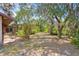 Spacious backyard with mature trees and landscaping at 2807 Country River Dr, Parrish, FL 34219