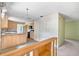 Open kitchen with island and access to hallway at 2807 Country River Dr, Parrish, FL 34219